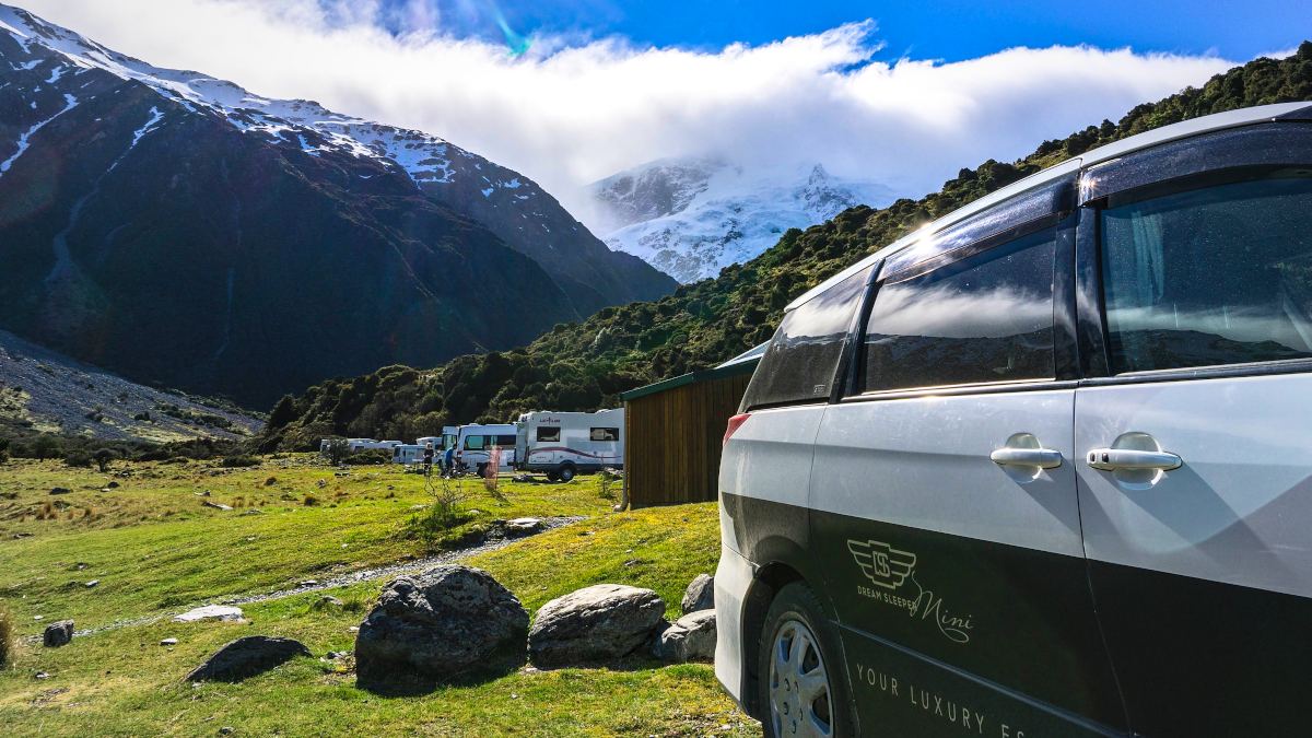 Compact campervan at Mt Cook campsite with a view of the mountain