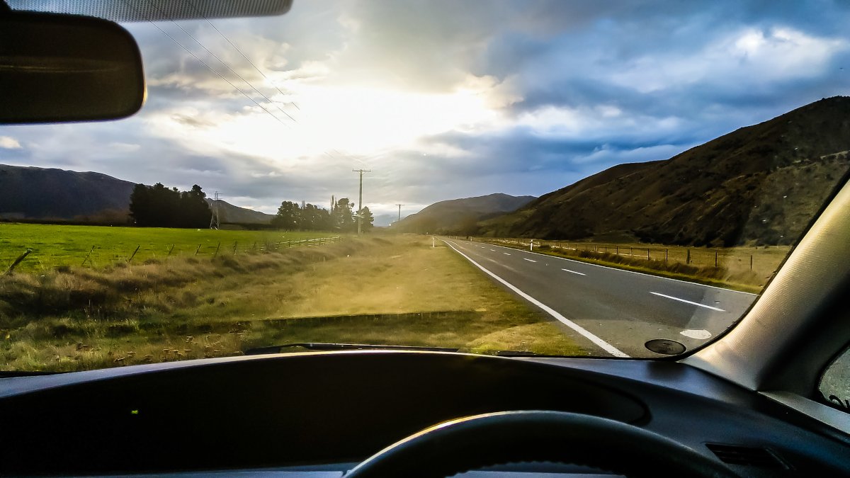 View through vehicle's front window - while parked on the side of the road. Sun is setting. Amazing view.