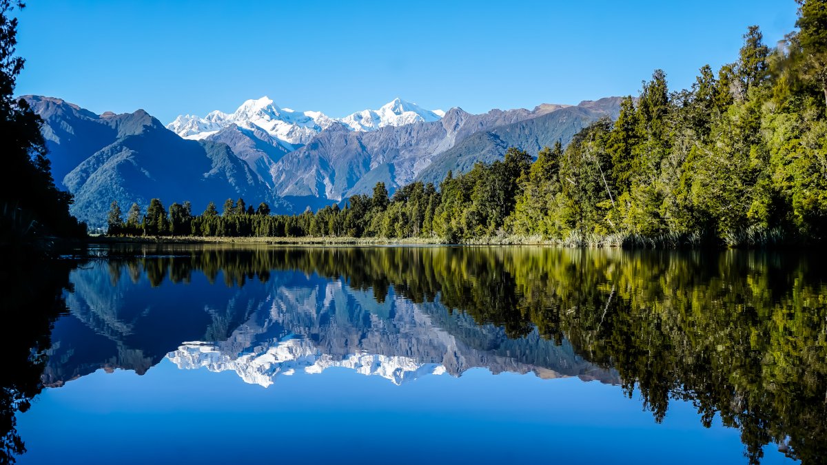Lake Mathesson: mountains reflecting in the water of the lake. Sunny day.