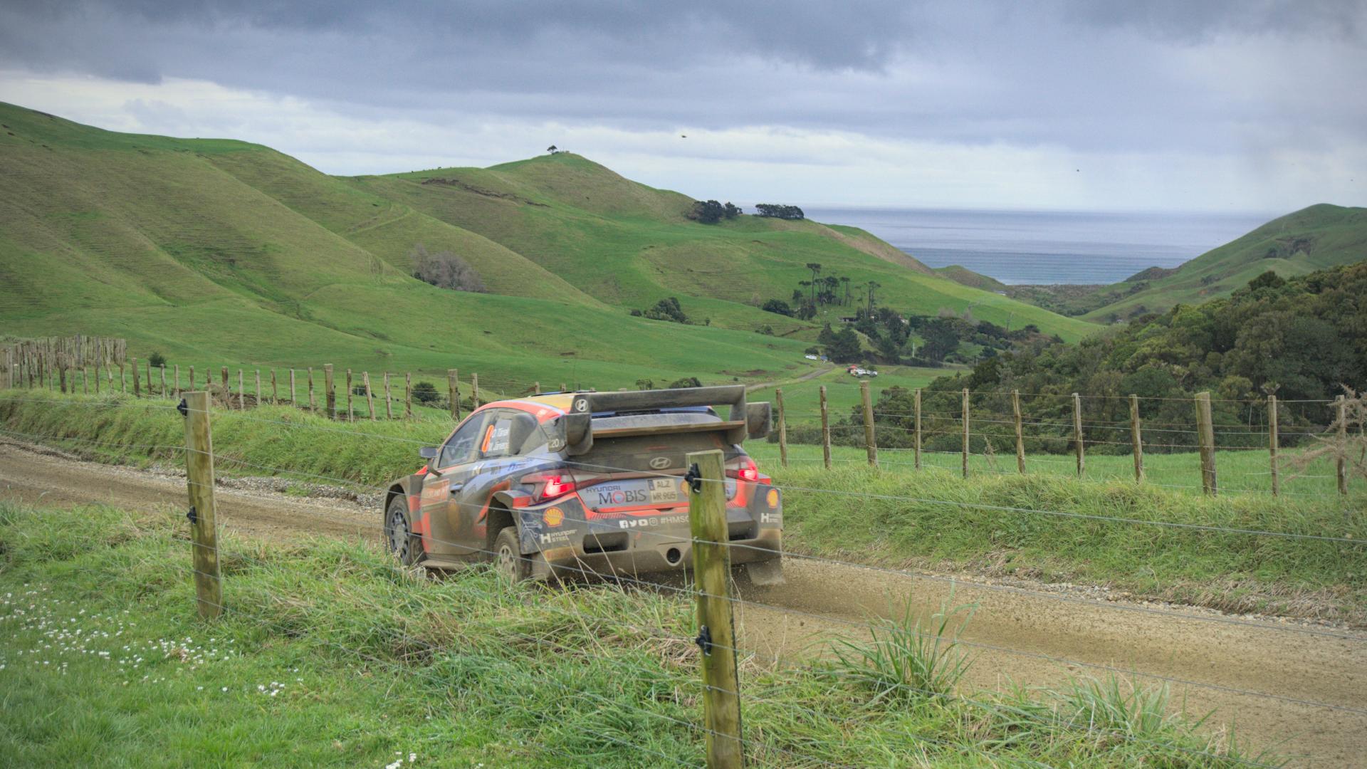 Car passing photographer - car on the left. Ocean behind it
